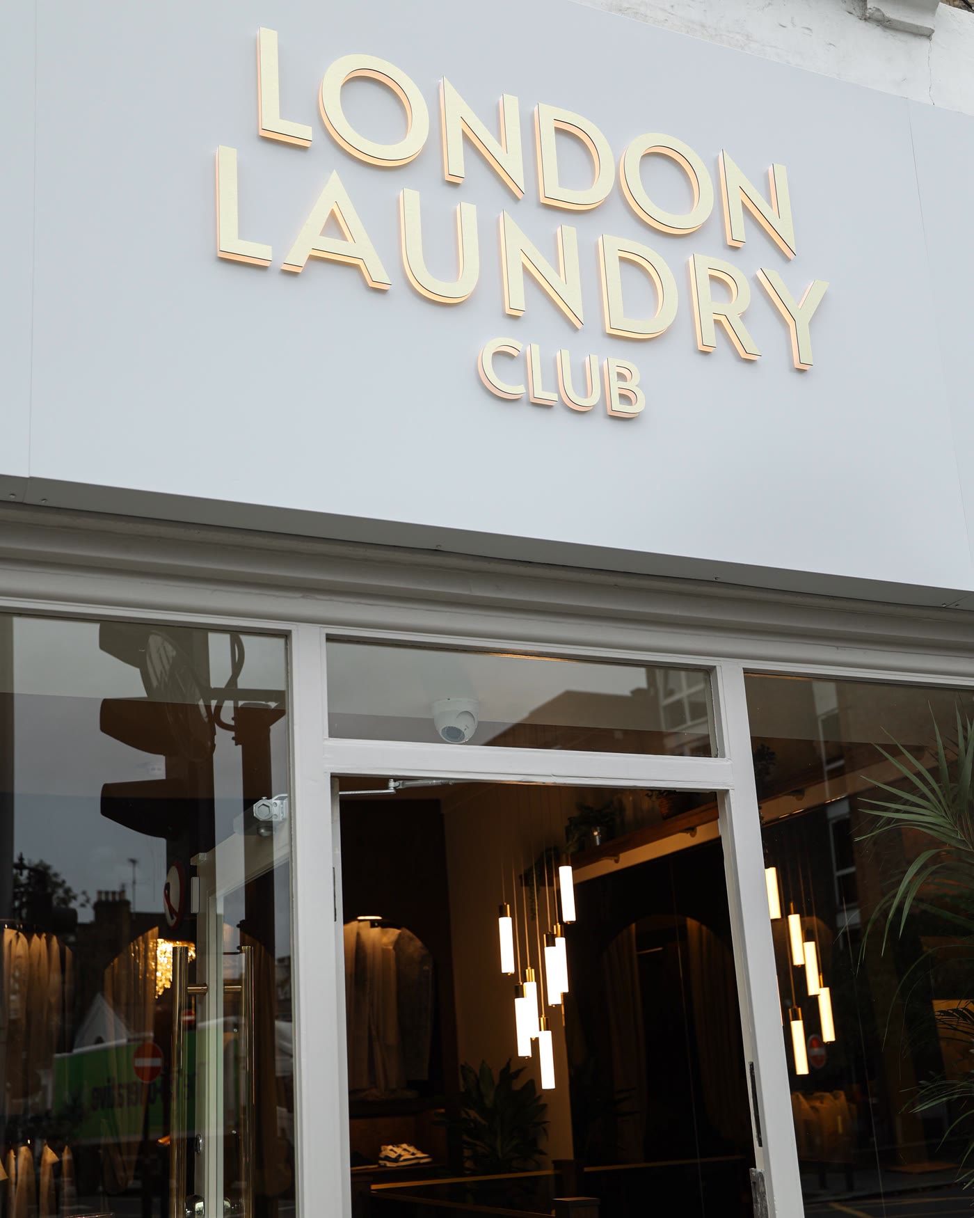 The London Laundry Club shopfront with its gold sign